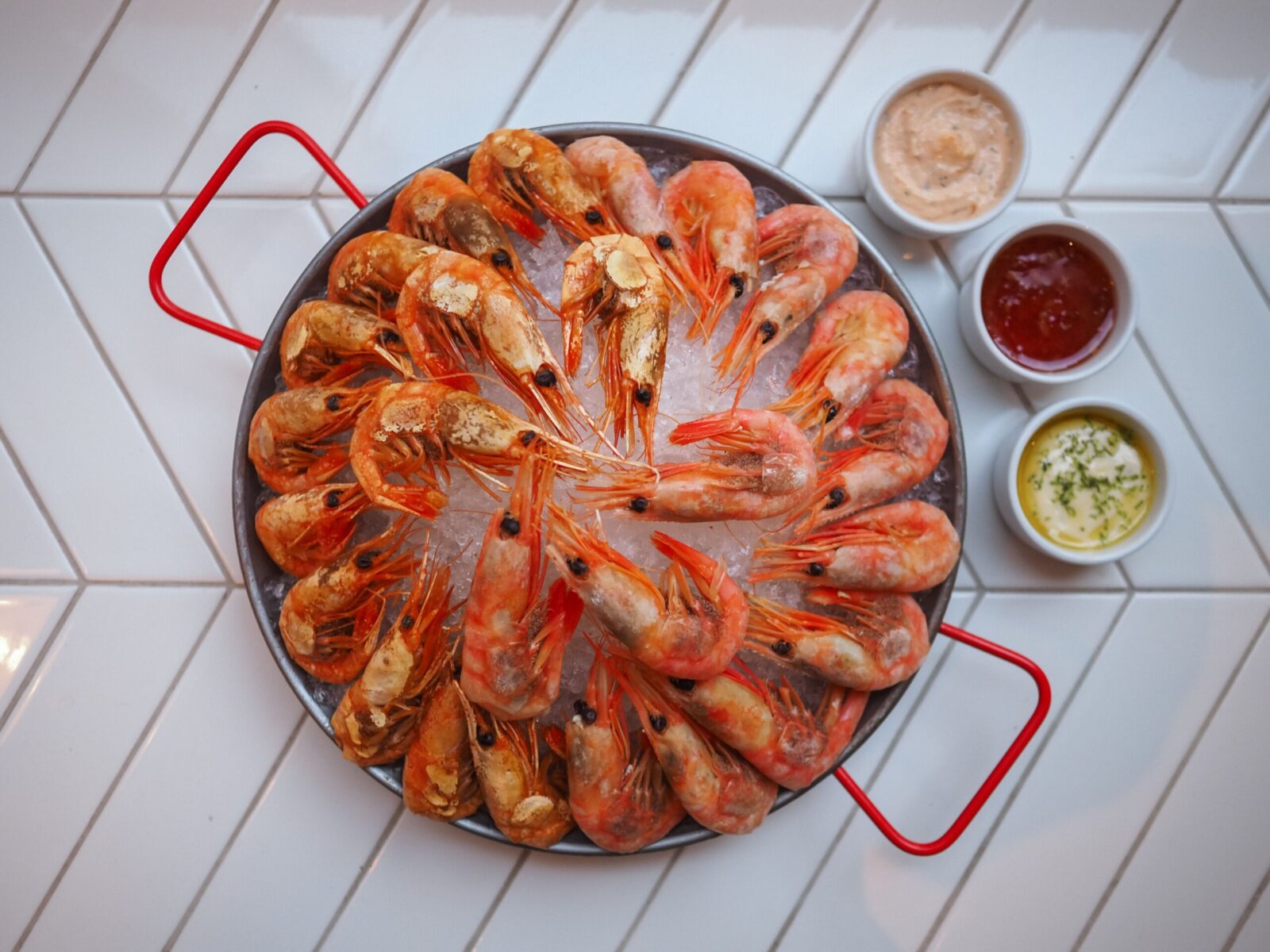 A vibrant seafood platter with ice-cold shrimps and flavorful dips. Perfect for seafood lovers.